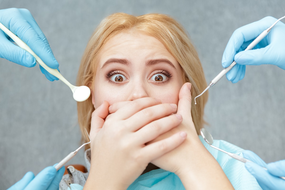 Terrified woman covering her mouth